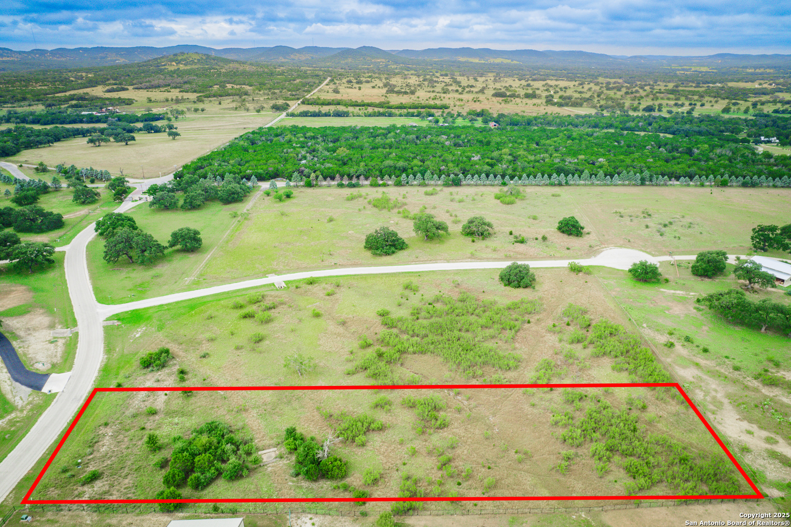 Lot 6 Bridlegate Boulevard Bandera, TX 78003 - Photo 3 of 6 a view of a lake with a mountain in the background