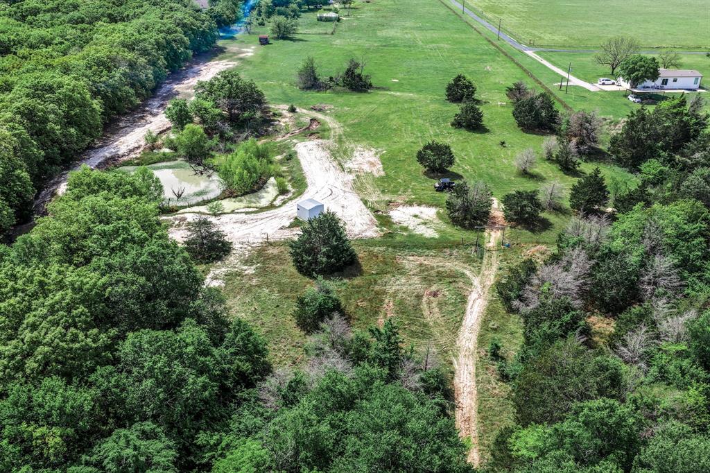 0 Fm 2101 Stuart, TX 74570 - Photo 10 of 32 an aerial view of a golf course with a lake view