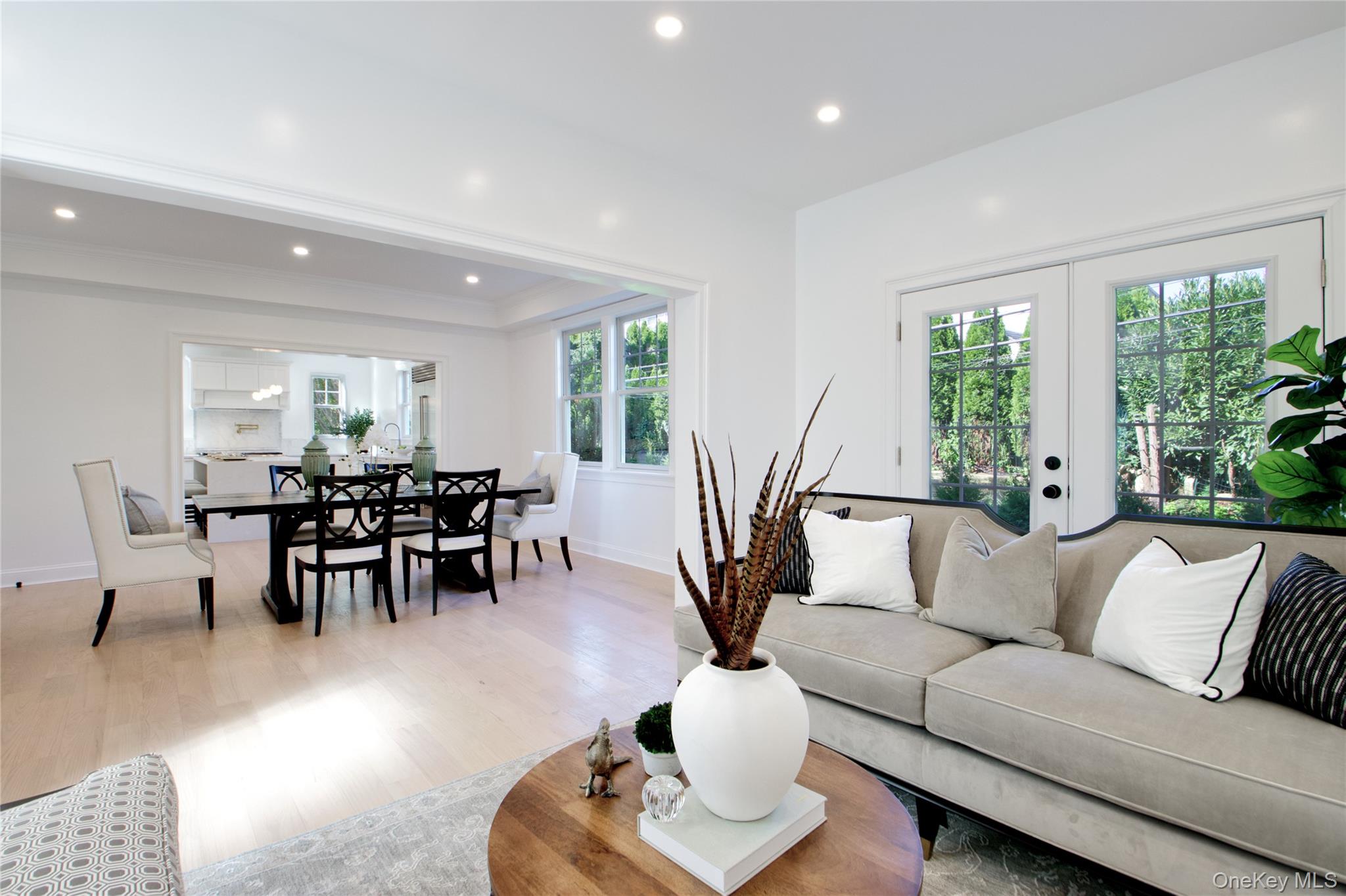 108 Tanners Pond Road Garden City, NY 11530 - Photo 12 of 27 Living area with wood finished floors, recessed lighting, and french doors