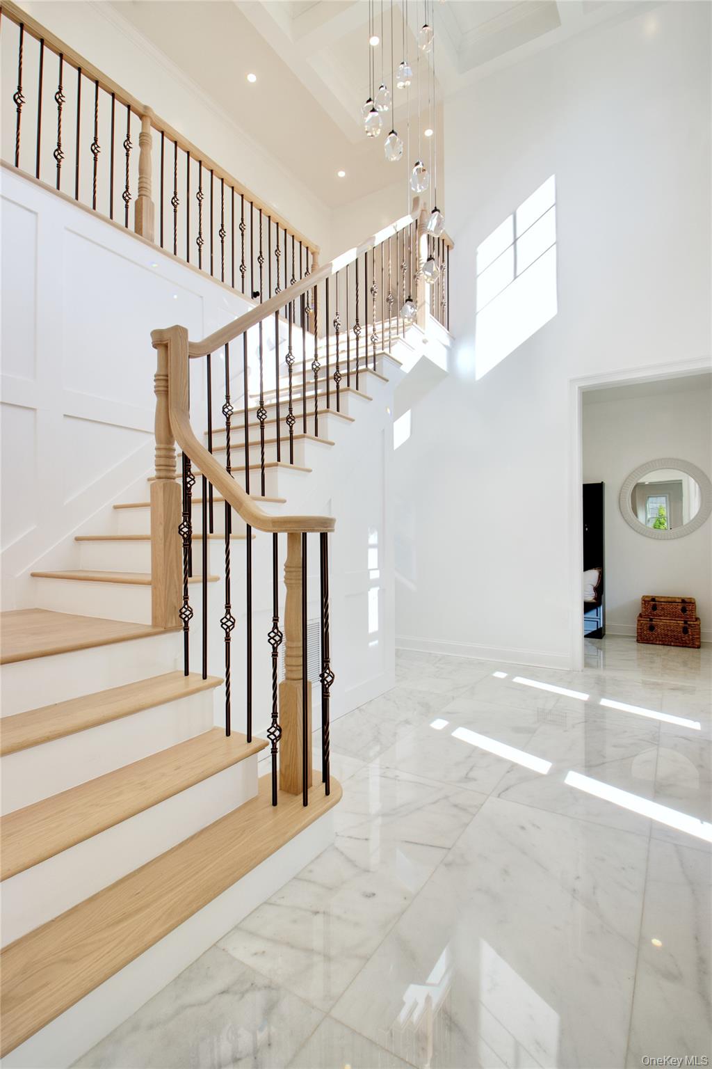 108 Tanners Pond Road Garden City, NY 11530 - Photo 2 of 27 Staircase with marble tiled floors, a high ceiling, recessed lighting, and beam ceiling