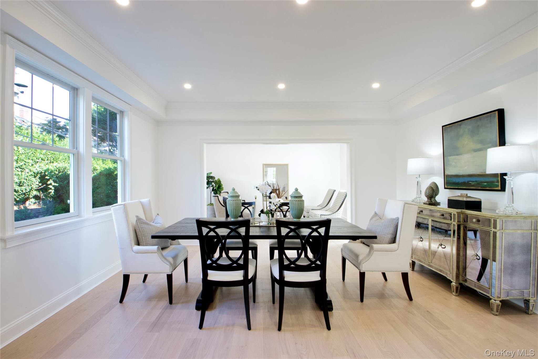108 Tanners Pond Road Garden City, NY 11530 - Photo 10 of 27 Dining room with light wood-type flooring, recessed lighting, and ornamental molding