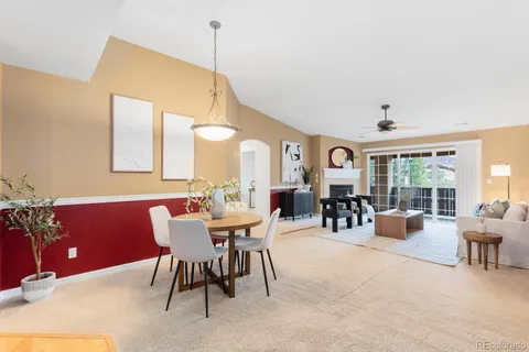 a dining room with furniture and a large window