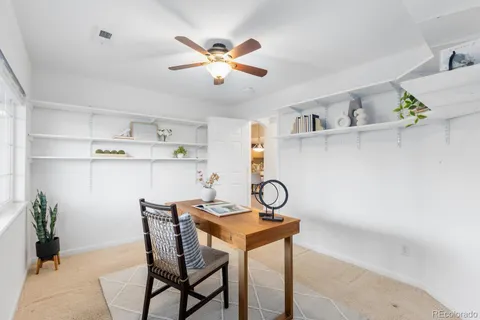 a view of a dining room with a table and chairs