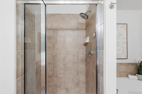 a bathroom with a glass shower door