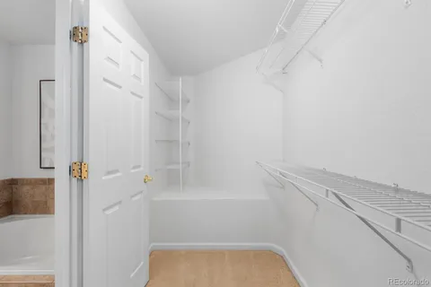 a bathroom with a tub shower and vanity