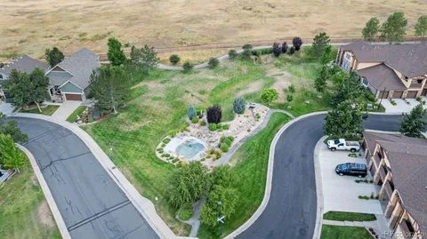 an aerial view of a house with a yard and lake view