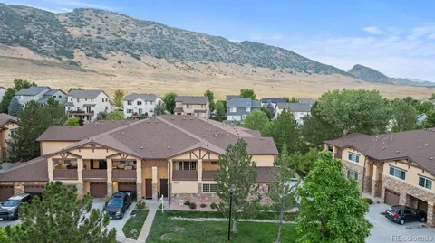 a view of a big house with a mountain in the background