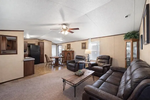 a living room with furniture and a chandelier