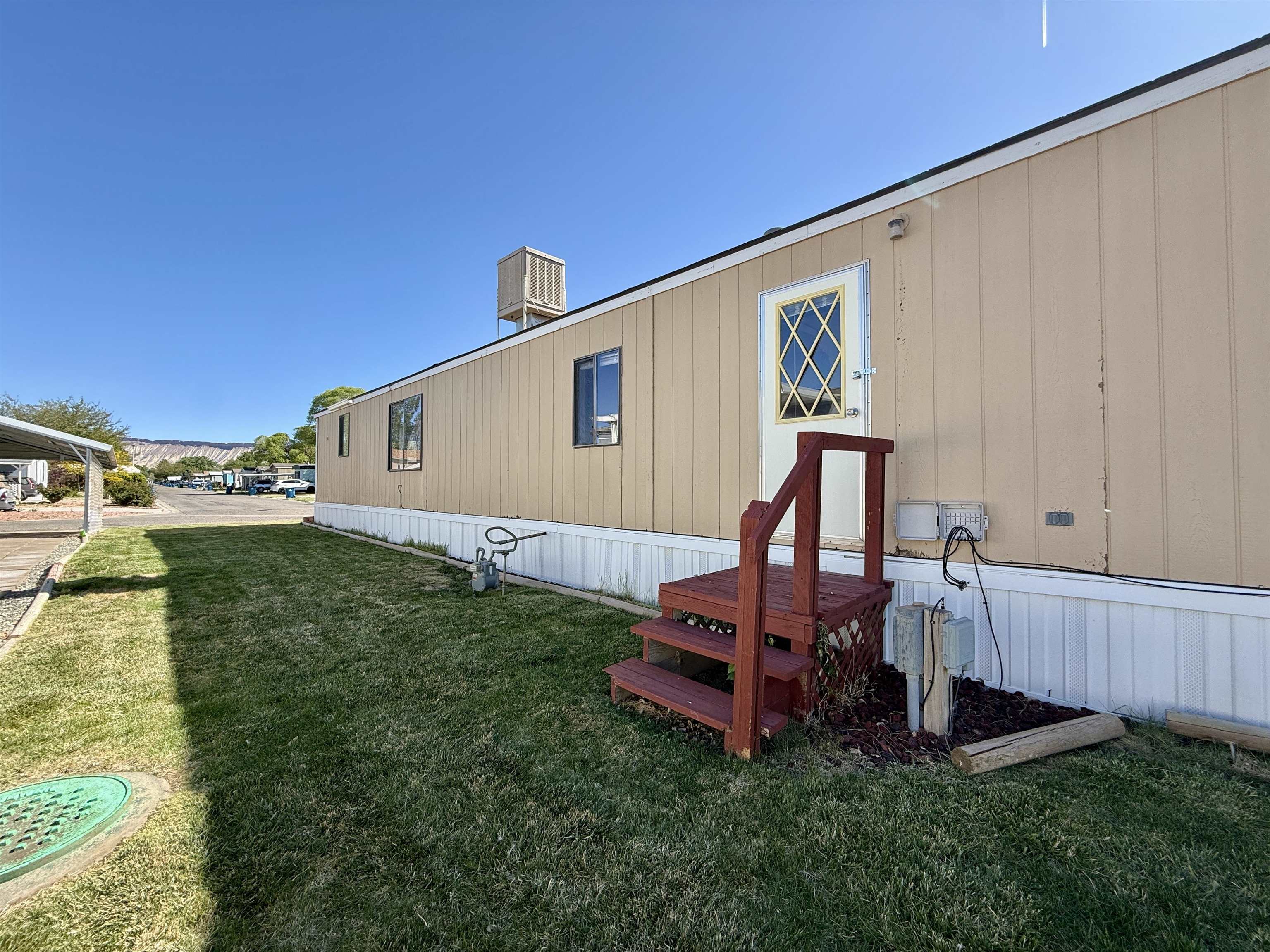 3251 E Road, Unit 33 Clifton, CO 81520 - Photo 27 of 28 a backyard of a house with table and chairs