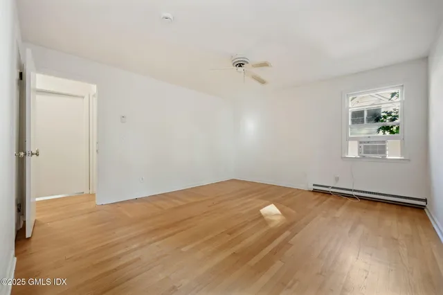 a bathroom with a shower sink vanity and toilet
