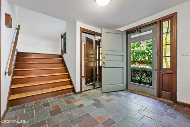 a view of entryway with wooden floor and door