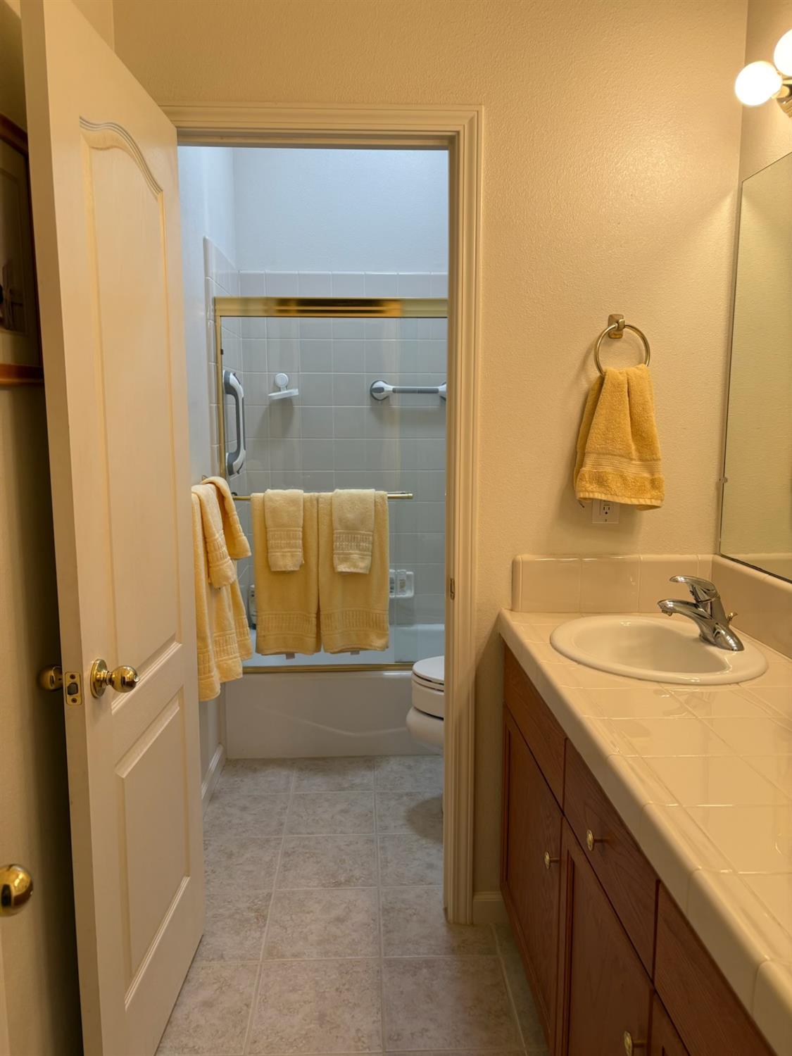 2644 Gibson Avenue Clovis, CA 93611 - Photo 15 of 21 a bathroom with a sink and a mirror