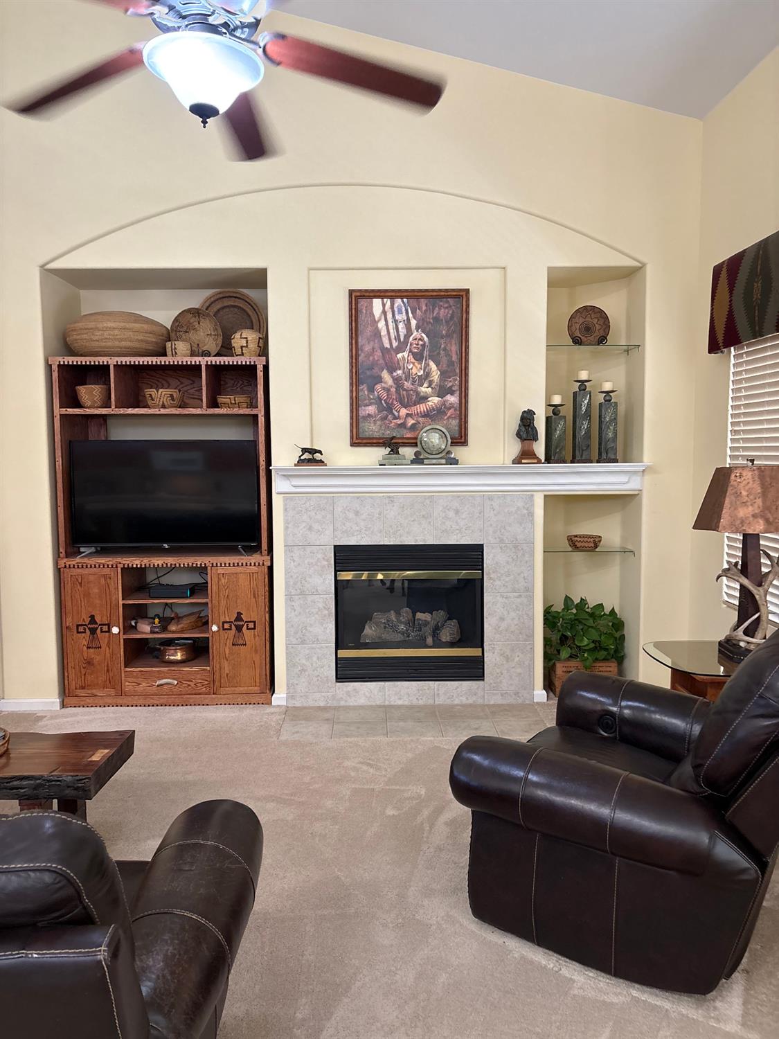 2644 Gibson Avenue Clovis, CA 93611 - Photo 2 of 21 a living room with furniture and a fireplace