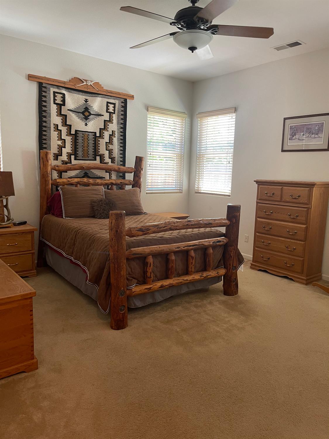 2644 Gibson Avenue Clovis, CA 93611 - Photo 9 of 21 a spacious bedroom with a bed and a dresser