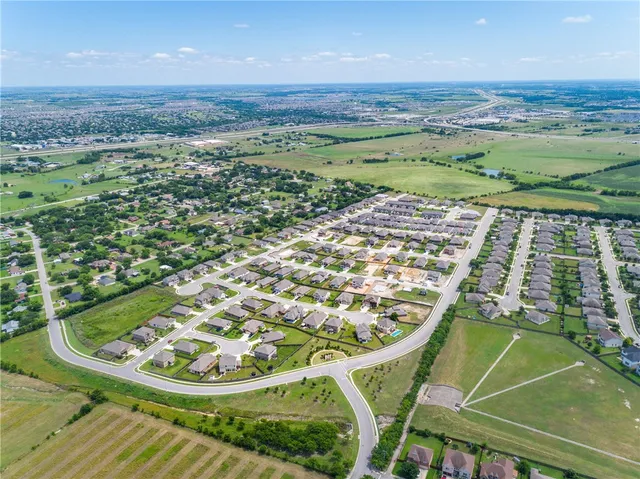 a view of a swimming pool with a yard and outdoor seating