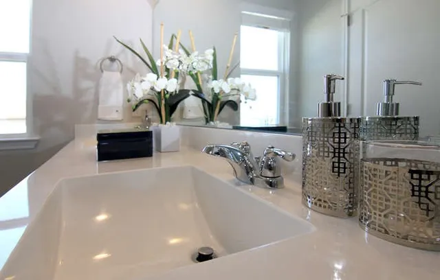 a bathroom with a sink a faucet and a mirror