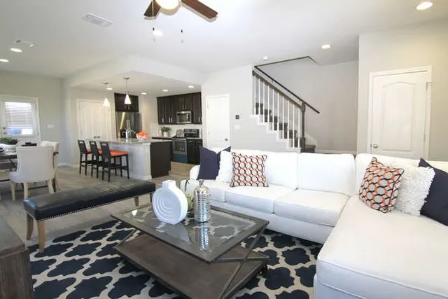 a living room with furniture and wooden floor