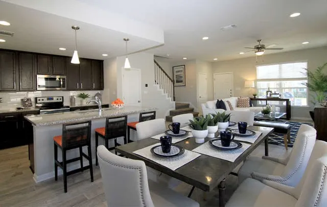 a kitchen with a dining table and chairs