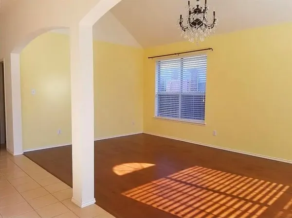 a view of a room with a window and wooden floor