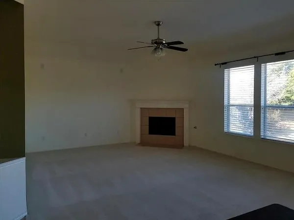 an empty room with a empty space and windows