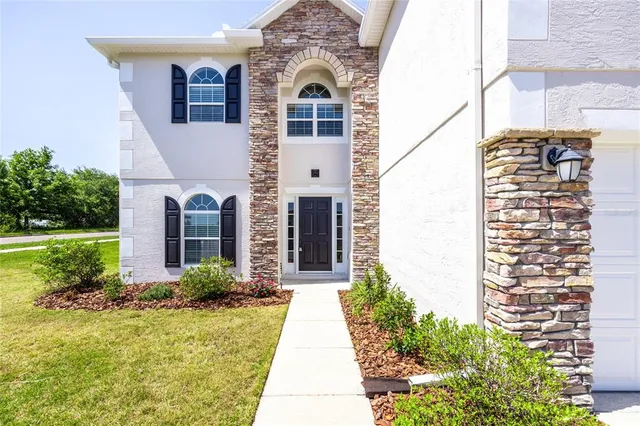 a front view of a house with a yard and garage