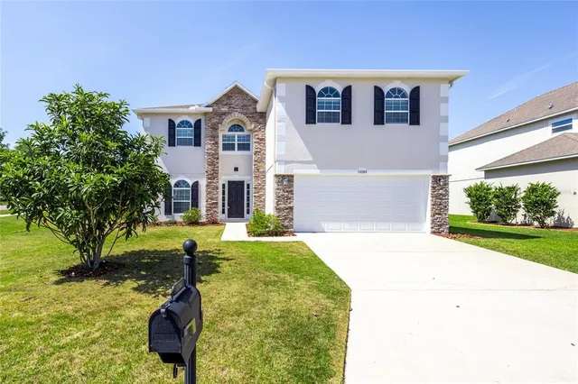 an empty room with wooden floor cabinet and windows