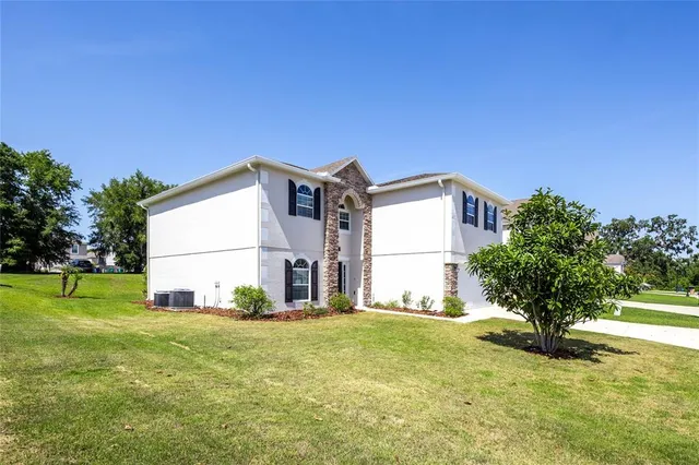 a view of a room with wooden floor and a ceiling fan