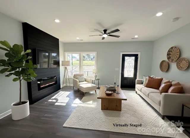 a living room with furniture potted plant and a window