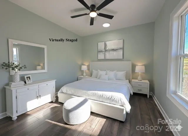 a bedroom with a bed and a chandelier fan