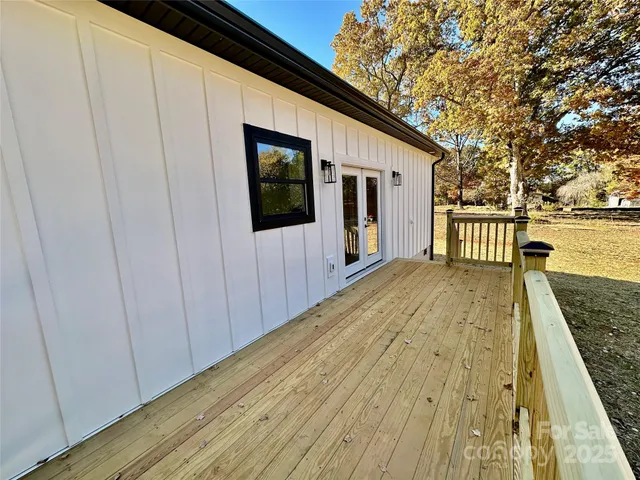 a view of a balcony with wooden floor and fence