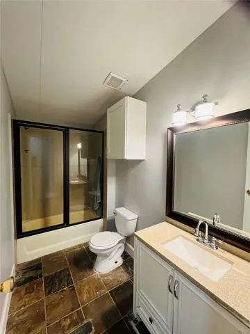 a bathroom with a sink toilet and mirror