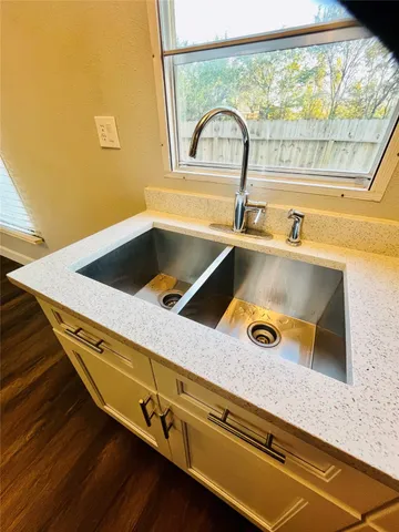 a view of a yard with plants and wooden fence