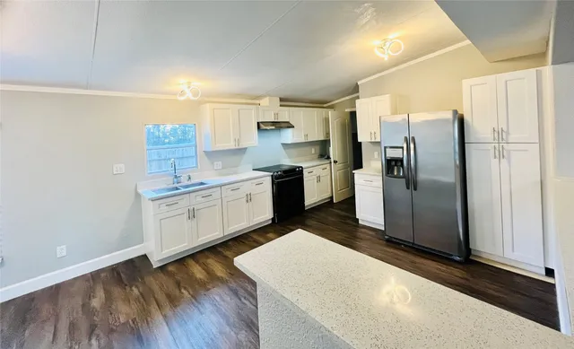 a kitchen with stainless steel appliances a refrigerator sink and microwave