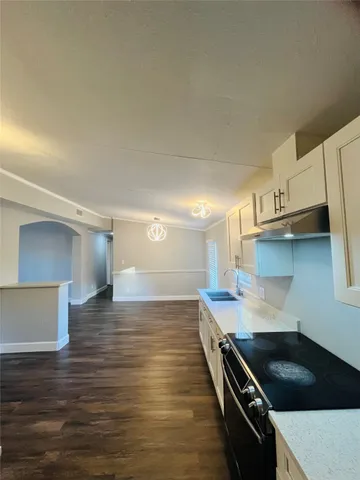 a kitchen with granite countertop a stove and a sink