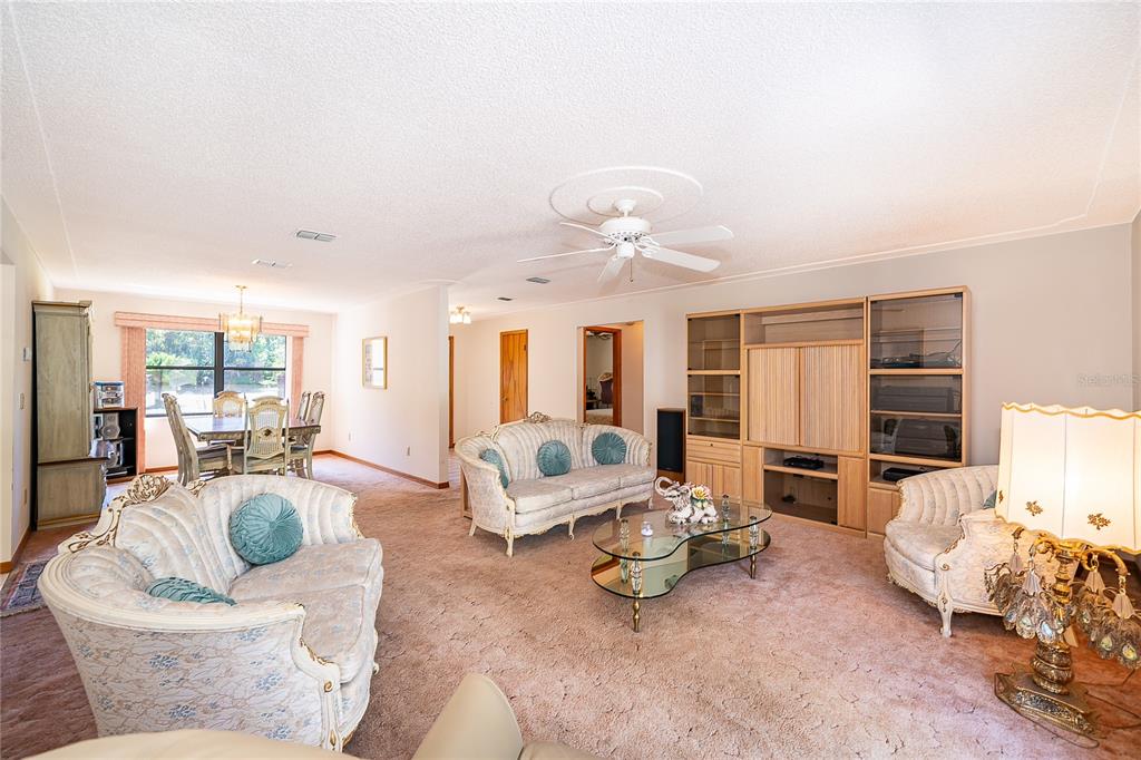 14604 Southwest 45th Circle Ocala, FL 34473 - Photo 11 of 28 a living room with furniture and a large window