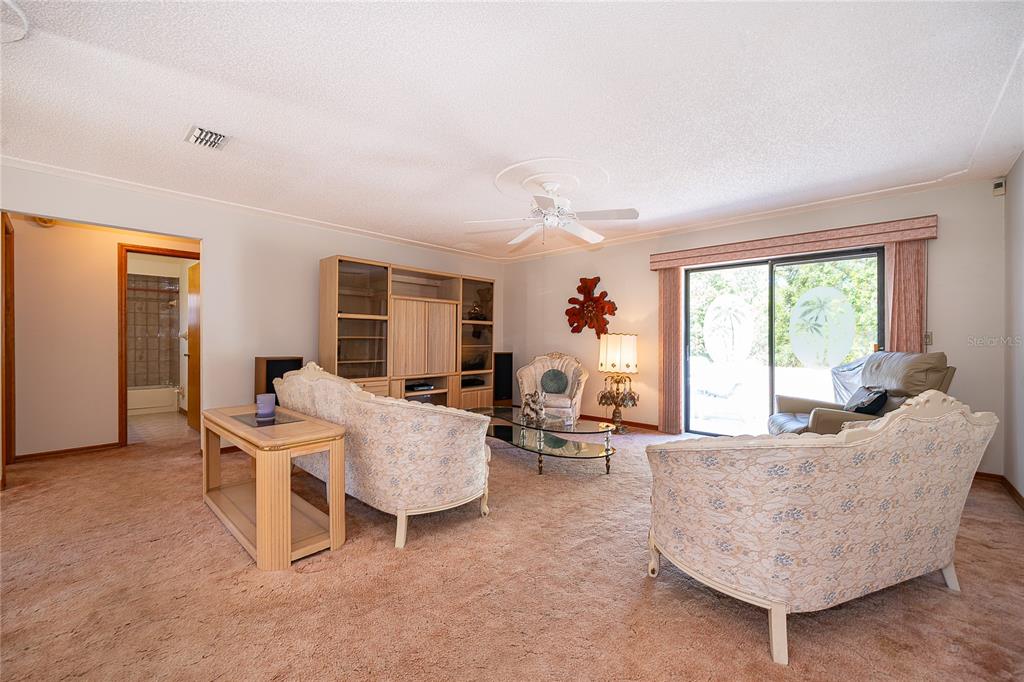 14604 Southwest 45th Circle Ocala, FL 34473 - Photo 12 of 28 a living room with furniture and a large window