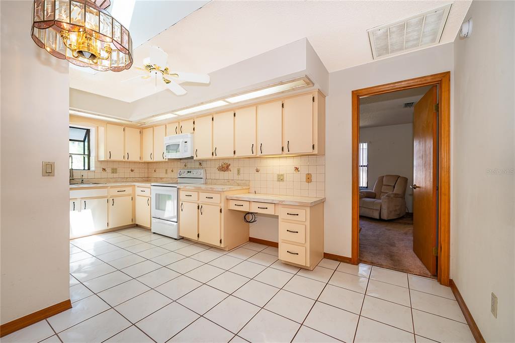 14604 Southwest 45th Circle Ocala, FL 34473 - Photo 15 of 28 a kitchen with white cabinets and appliances