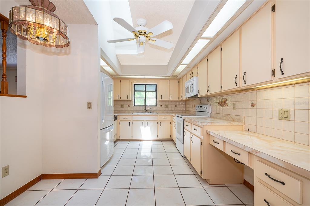 14604 Southwest 45th Circle Ocala, FL 34473 - Photo 16 of 28 a large white kitchen with a window and cabinets