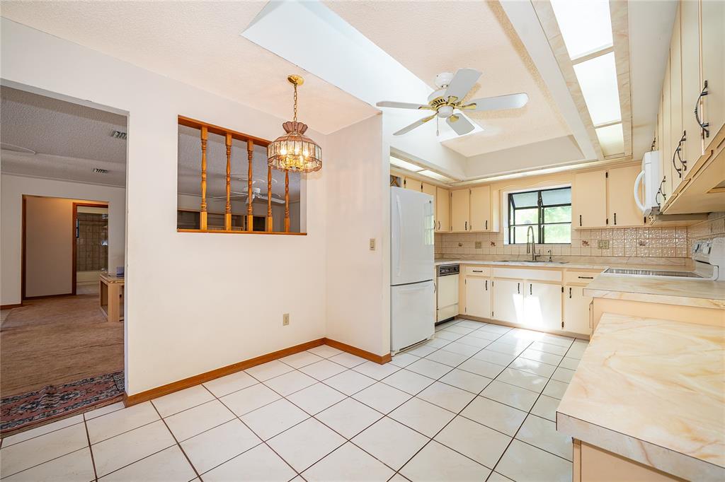 14604 Southwest 45th Circle Ocala, FL 34473 - Photo 17 of 28 a kitchen with a stove a sink and a refrigerator