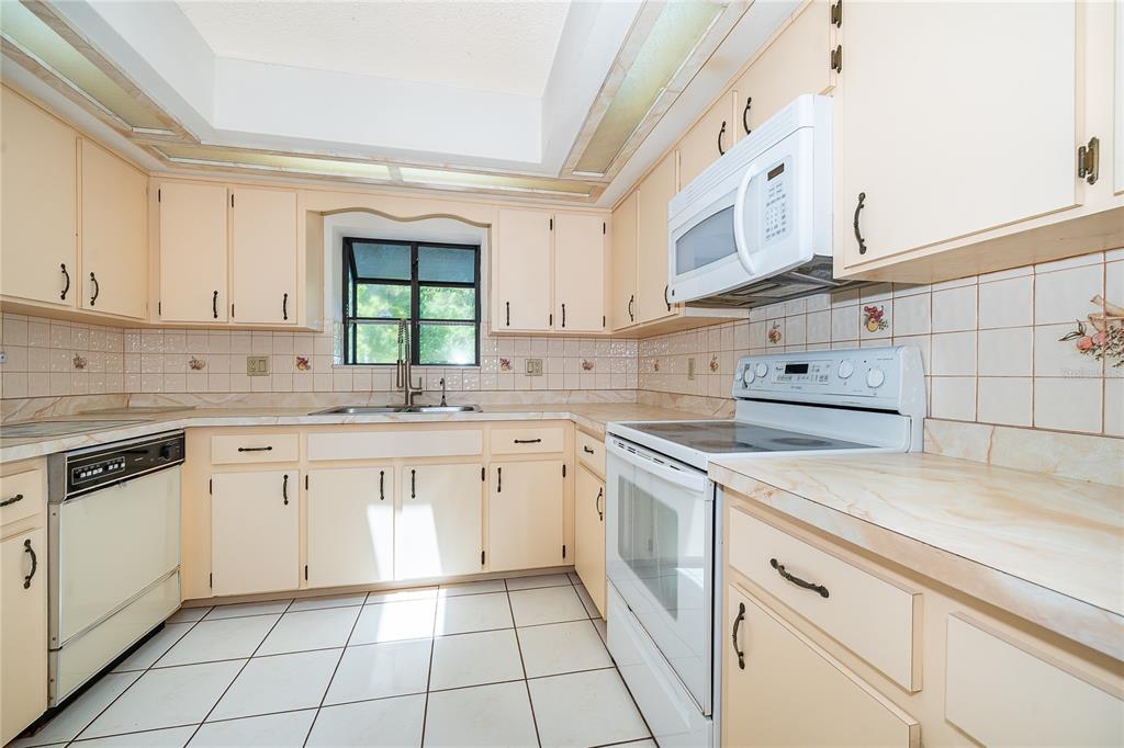 14604 Southwest 45th Circle Ocala, FL 34473 - Photo 18 of 28 a kitchen with cabinets appliances a sink and a window