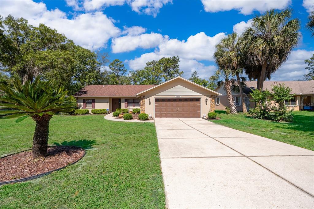 14604 Southwest 45th Circle Ocala, FL 34473 - Photo 4 of 28 a front view of a house with garden