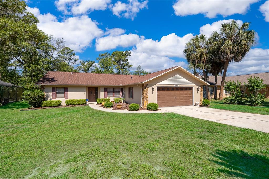14604 Southwest 45th Circle Ocala, FL 34473 - Photo 7 of 28 a view of a house with a yard and a garden