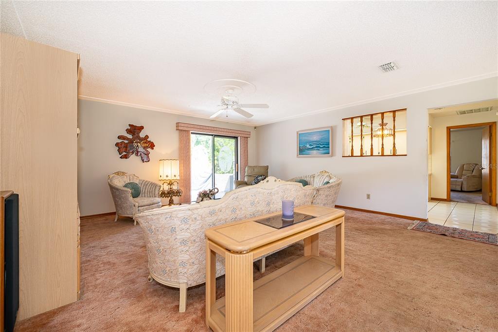 14604 Southwest 45th Circle Ocala, FL 34473 - Photo 9 of 28 a living room with a couch and a window