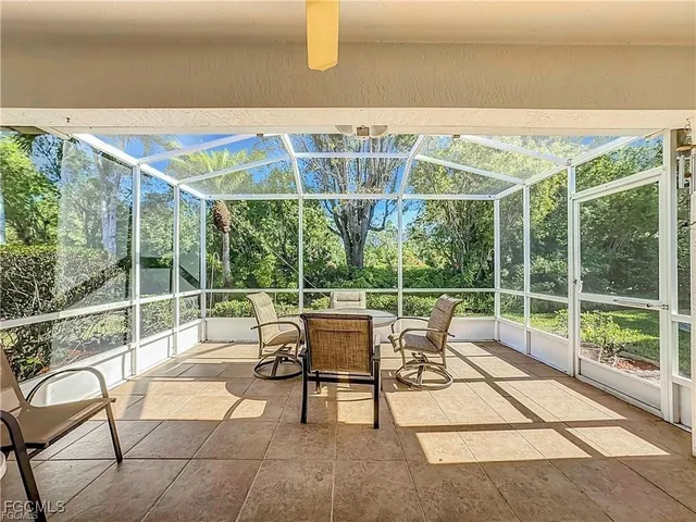 a view of a patio with a dining table and chairs