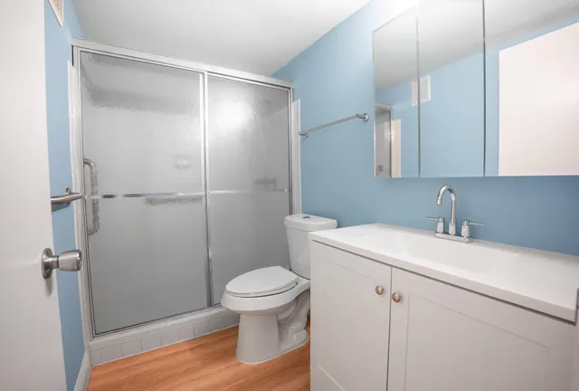 a bathroom with a sink toilet and shower