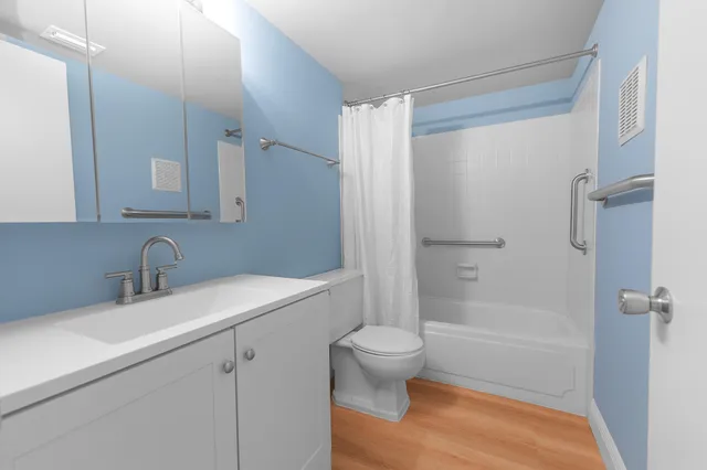 a bathroom with a sink toilet and shower