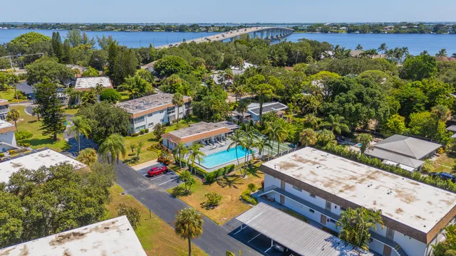an aerial view of a house with a garden and lake view
