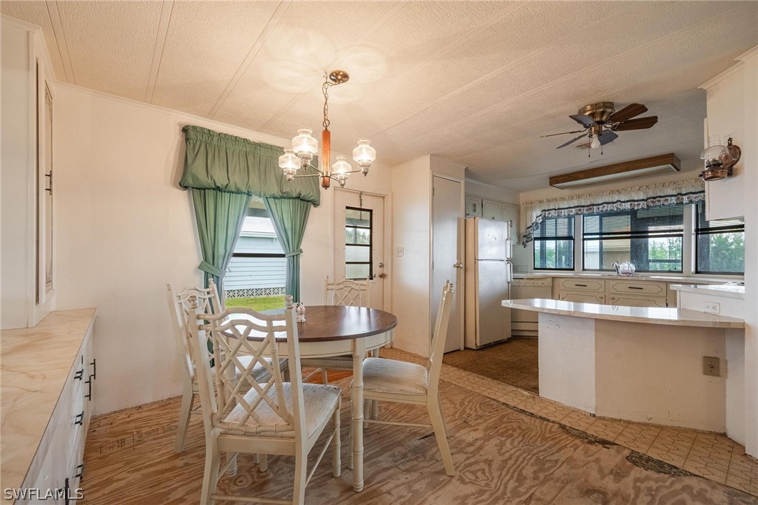 27 Aloe Alva, FL 33920 - Photo 14 of 33 a view of a dining room with furniture a chandelier and wooden floor