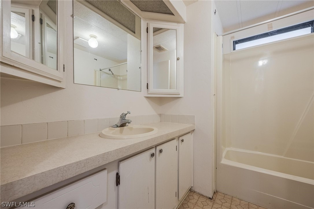 27 Aloe Alva, FL 33920 - Photo 16 of 33 a bathroom with a sink and a mirror