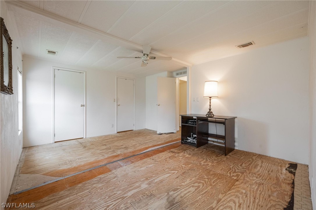 27 Aloe Alva, FL 33920 - Photo 19 of 33 a bedroom with a bed and a table in it